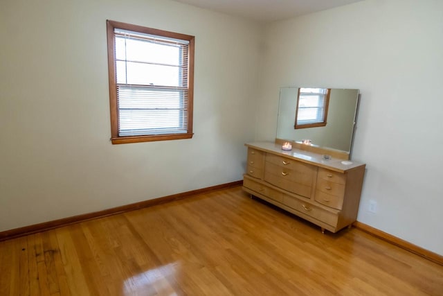 unfurnished bedroom featuring light wood-style floors and baseboards