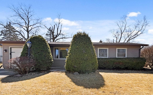 view of front of home with a front yard and an attached garage