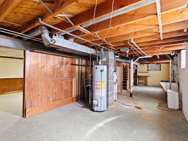 unfinished below grade area with gas water heater and wood walls