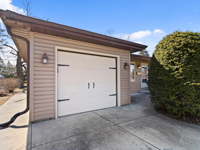 garage with concrete driveway