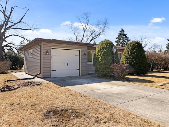 ranch-style house featuring concrete driveway and an attached garage