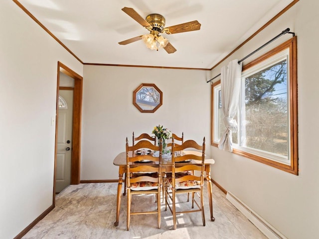 dining space with ceiling fan, baseboards, baseboard heating, and ornamental molding