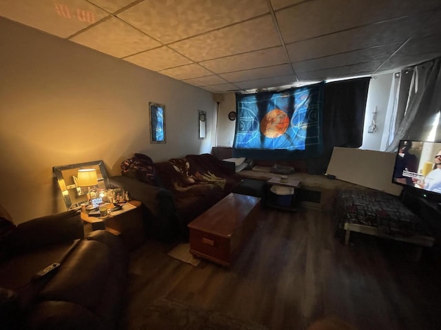 home theater room featuring a drop ceiling and wood finished floors