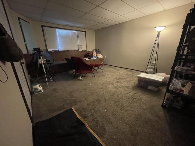 living room with a paneled ceiling and carpet floors