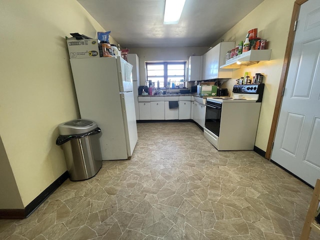 kitchen with baseboards, white appliances, stone finish floor, and white cabinetry