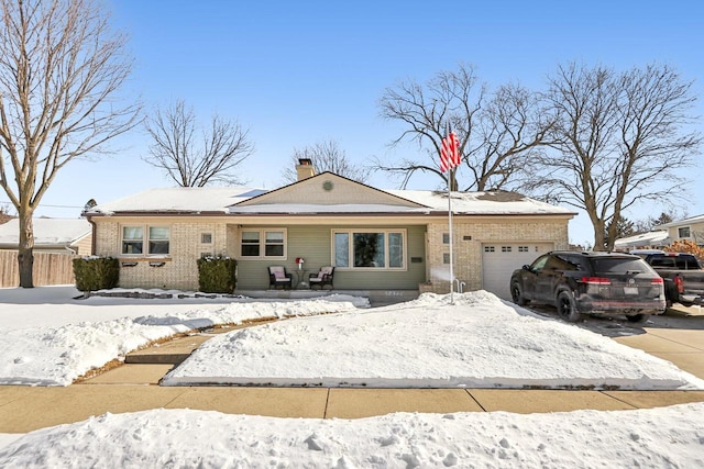 view of front of house featuring fence, driveway, a chimney, a garage, and brick siding