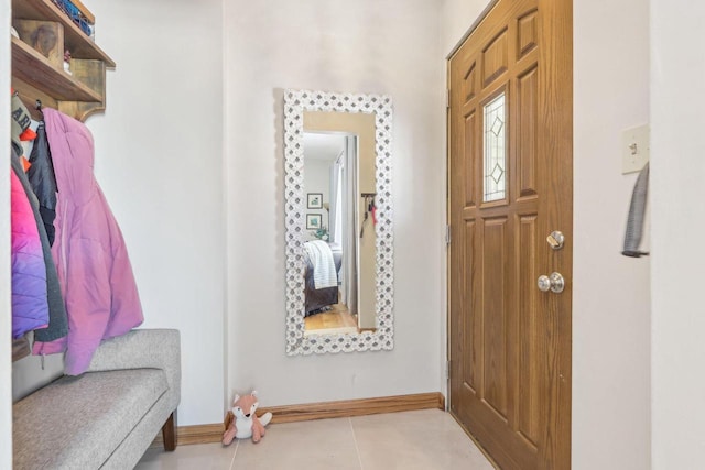 entrance foyer with baseboards and tile patterned flooring