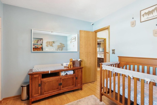 bedroom with baseboards and light wood-style flooring