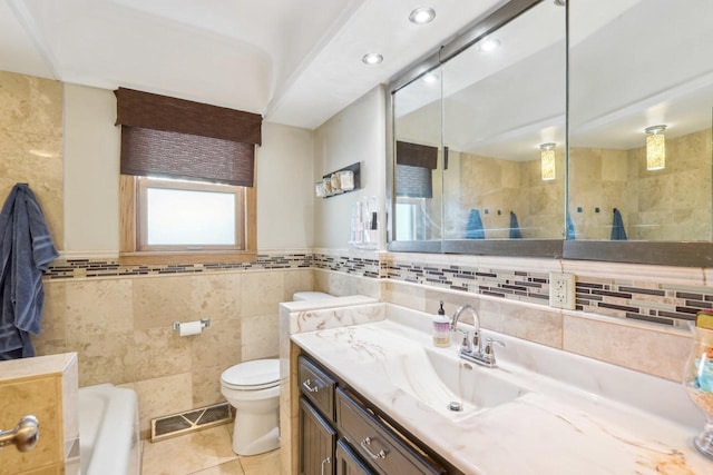 bathroom with tile patterned floors, visible vents, toilet, tile walls, and vanity