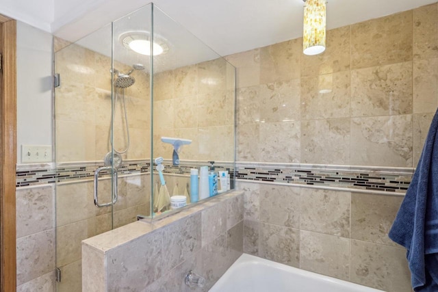 full bath featuring a shower stall and a bathing tub