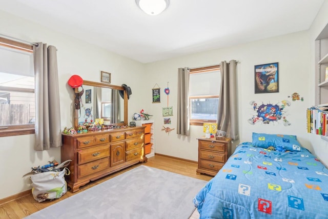 bedroom featuring light wood-type flooring and baseboards