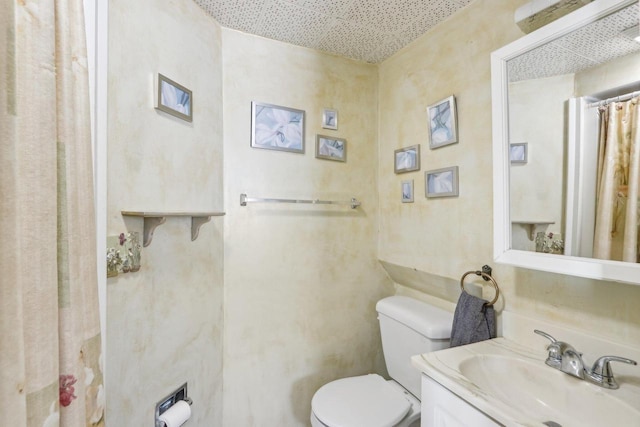 bathroom featuring toilet and vanity