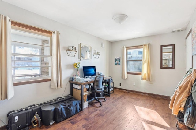 office area with baseboards and wood finished floors