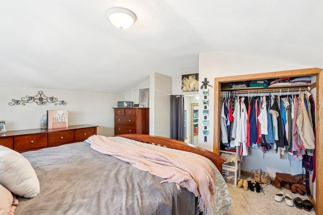 bedroom featuring a closet, lofted ceiling, and carpet floors