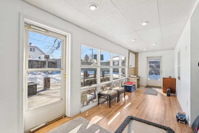 sunroom / solarium with a paneled ceiling