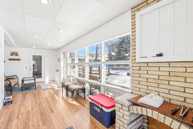 sunroom featuring a paneled ceiling