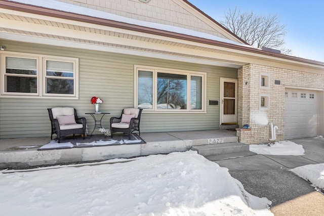 snow covered patio featuring covered porch