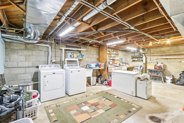 unfinished basement featuring fridge and independent washer and dryer