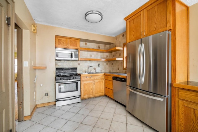 kitchen featuring open shelves, backsplash, brown cabinets, and appliances with stainless steel finishes