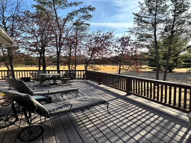 wooden terrace featuring outdoor dining area