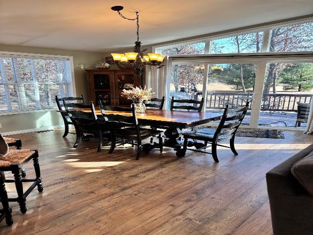 dining space featuring an inviting chandelier and wood finished floors