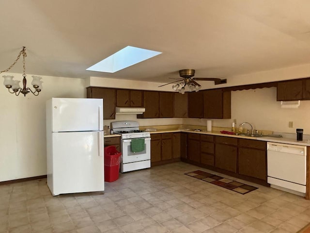 kitchen featuring a sink, white appliances, a ceiling fan, and light countertops