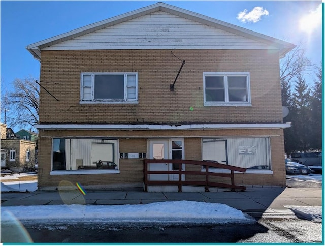 back of property featuring brick siding