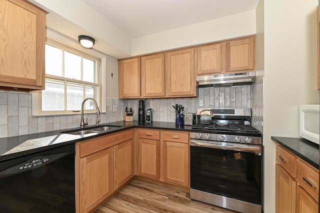 kitchen featuring under cabinet range hood, dishwasher, decorative backsplash, stainless steel gas stove, and a sink