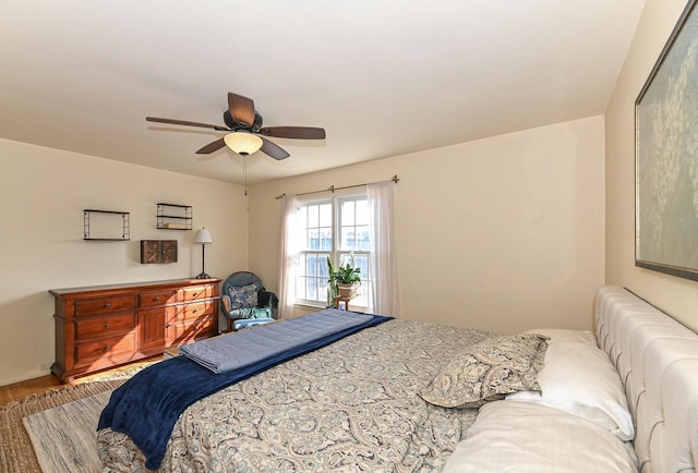 bedroom featuring wood finished floors and a ceiling fan