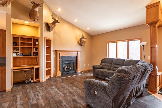 living room with baseboards, dark wood-type flooring, a glass covered fireplace, and built in study area