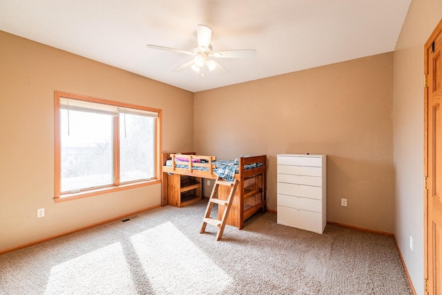 carpeted bedroom featuring visible vents, baseboards, and ceiling fan