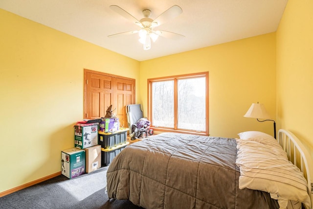 carpeted bedroom featuring a ceiling fan and baseboards