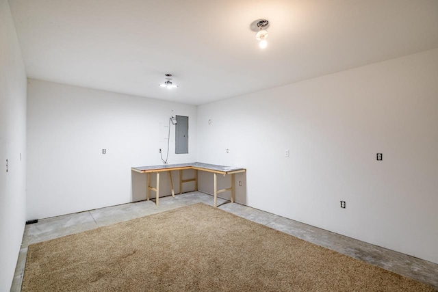 empty room featuring electric panel and concrete flooring