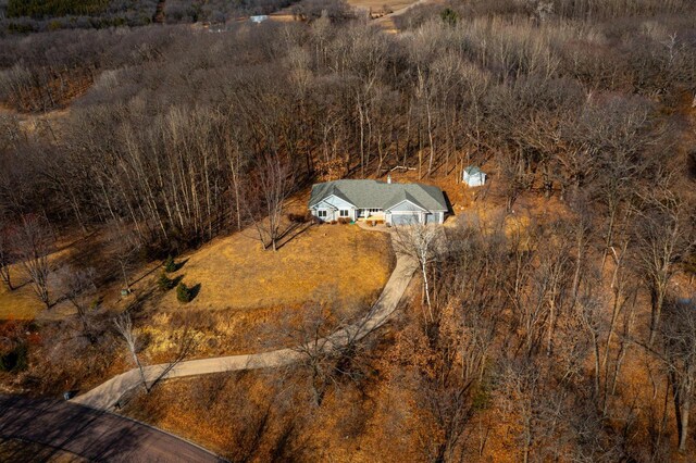 birds eye view of property featuring a view of trees