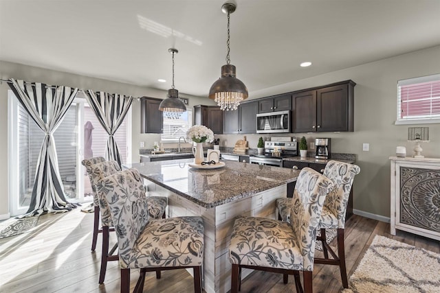 dining space with recessed lighting, baseboards, and light wood finished floors