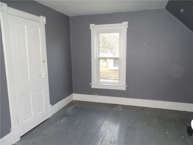 bonus room with baseboards, lofted ceiling, and wood-type flooring