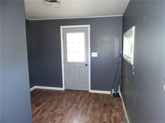 entryway featuring baseboards, wood finished floors, and ornamental molding