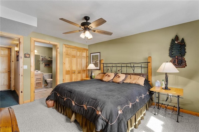 bedroom with connected bathroom, baseboards, carpet, and ceiling fan