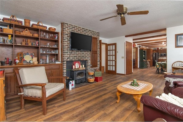 227 Donatelle St, Amery, WI 54001 - living area with ceiling fan, a wood stove, wood finished floors, and a textured ceiling
