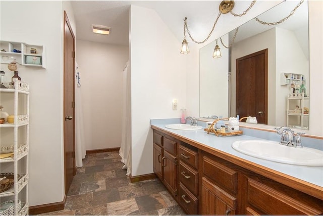 227 Donatelle St, Amery, WI 54001 - bathroom with double vanity, visible vents, stone finish flooring, and a sink