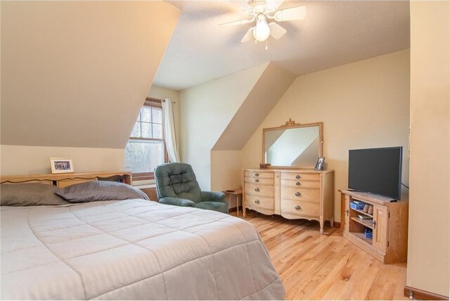 227 Donatelle St, Amery, WI 54001 - bedroom featuring ceiling fan, vaulted ceiling, and light wood finished floors