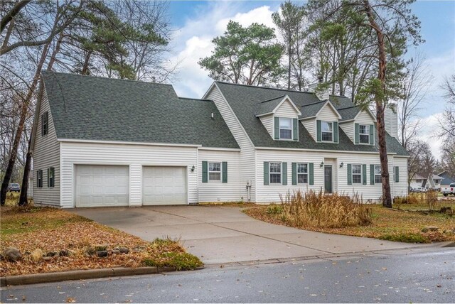 227 Donatelle St, Amery, WI 54001 - cape cod-style house featuring driveway, roof with shingles, and an attached garage