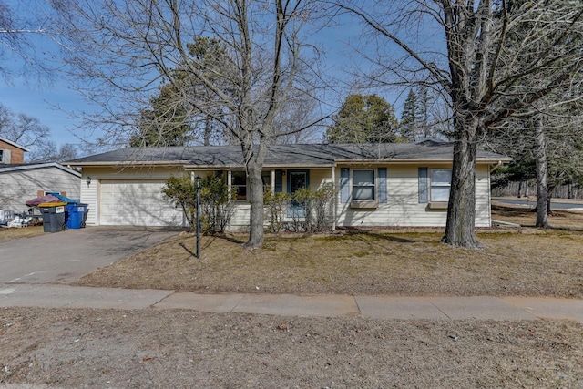 ranch-style home with driveway and an attached garage