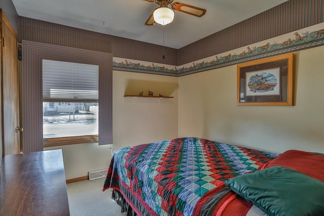 bedroom with visible vents, carpet flooring, baseboards, and ceiling fan