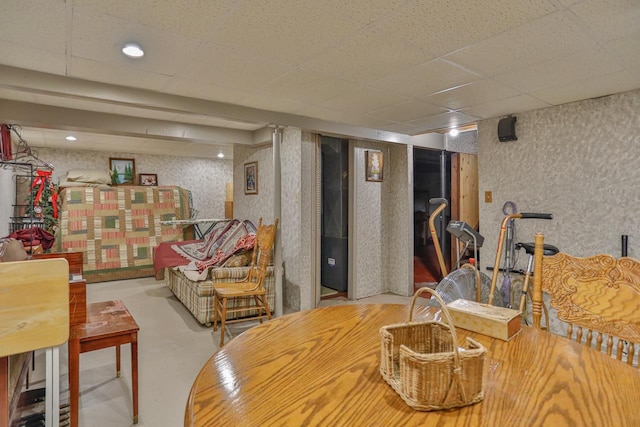 living area with wallpapered walls and a textured wall