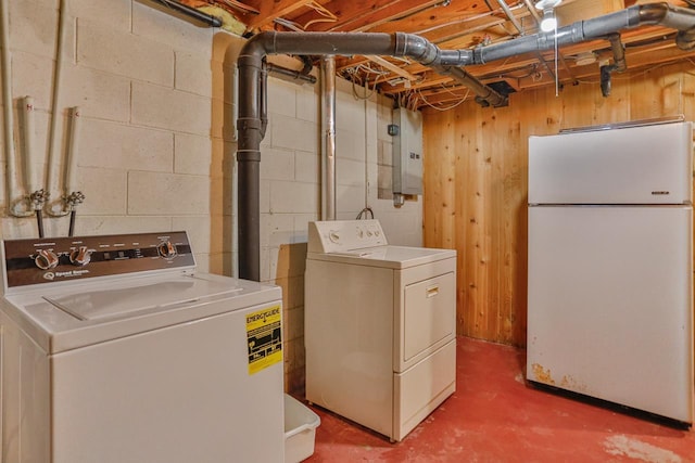 washroom with electric panel, independent washer and dryer, and laundry area