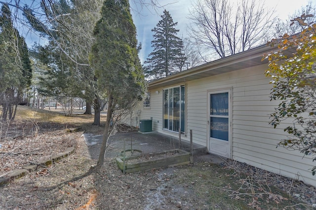 view of yard with central air condition unit and a garden