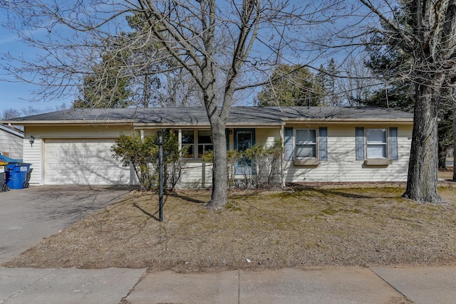 single story home with aphalt driveway and an attached garage