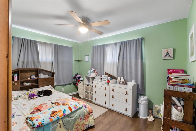 bedroom with ceiling fan and wood finished floors