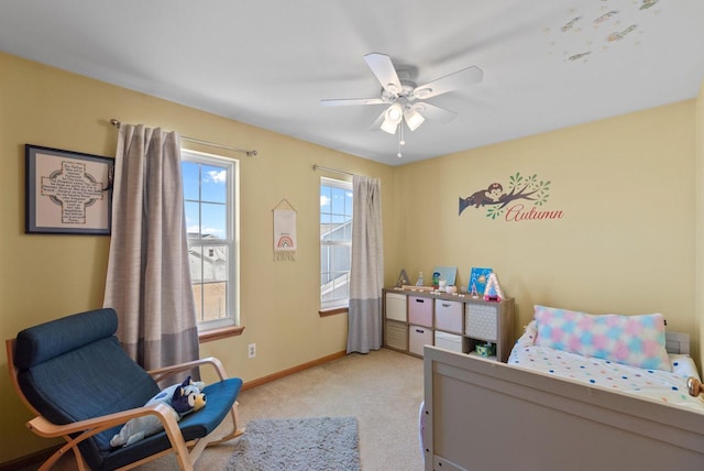 carpeted bedroom with baseboards and a ceiling fan